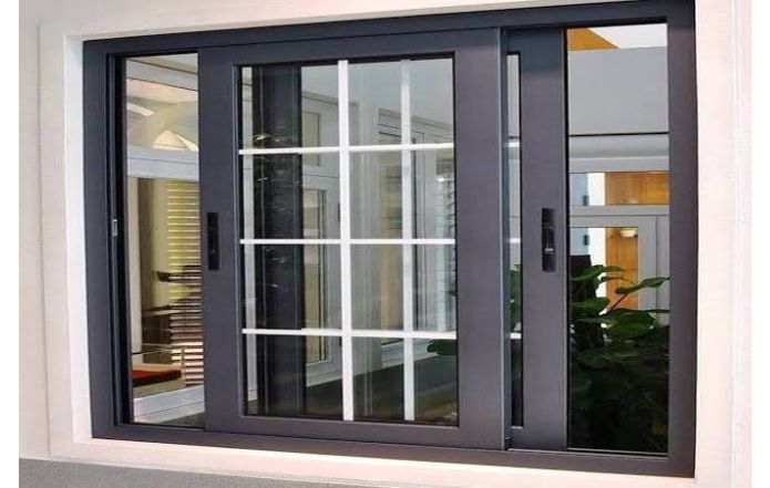 Modern sliding glass window featuring a sleek black aluminum frame and large glass panels. The contemporary design allows plenty of natural light into the interior while providing a clean, stylish appearance suitable for homes, offices, and commercial spaces.
