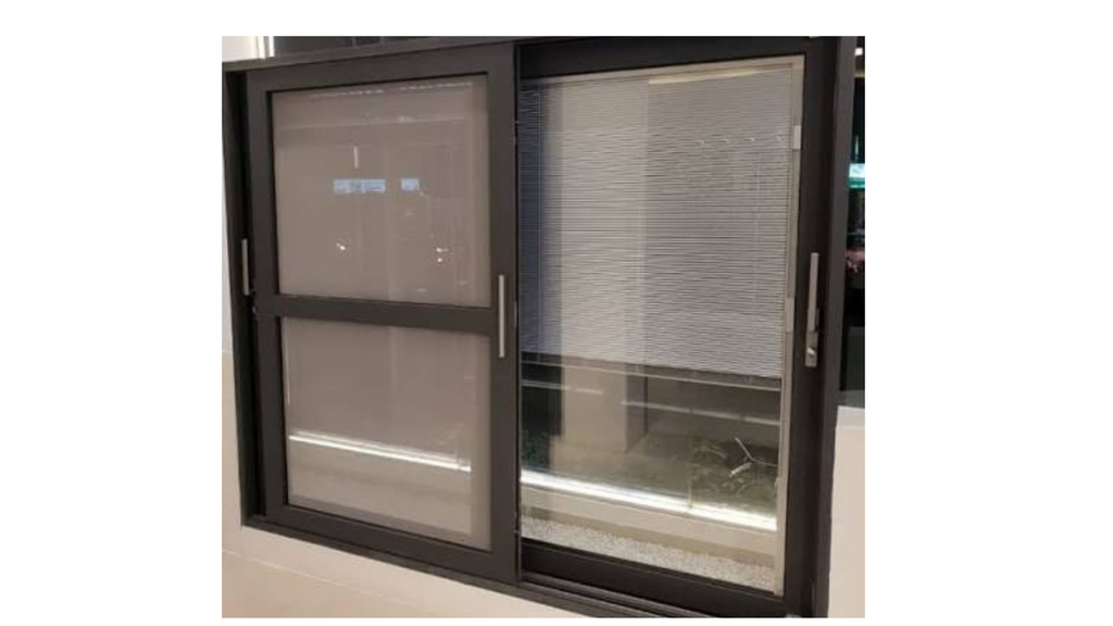A contemporary heavy-duty aluminium sliding door frame finished in matte dark grey/charcoal. The right panel showcases double-glazed tempered glass with integrated internal horizontal blinds, while the left panel incorporates a reinforced insect screen mesh and sleek vertical pull handles. Ideal for modern patio, balcony, or interior partition installations.
